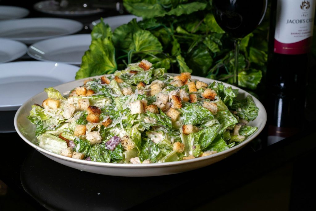 Delicious caesar salad is presented on a table