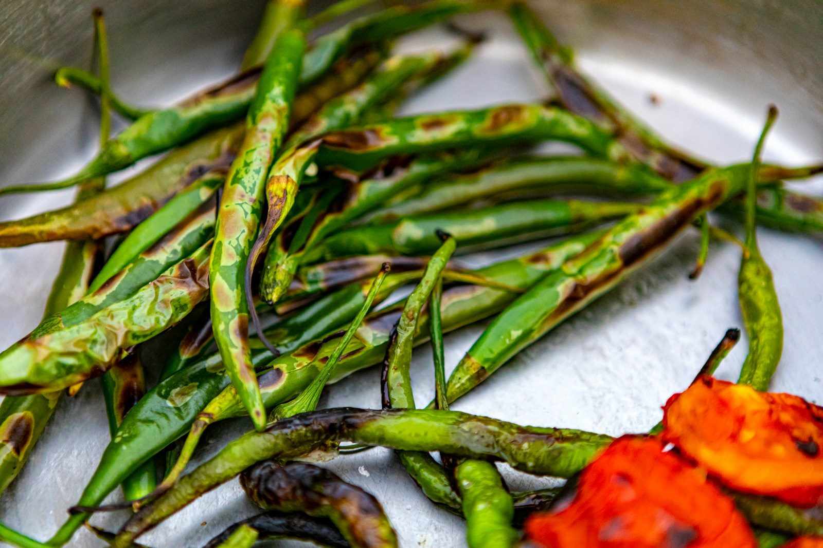 green chili on white textile
